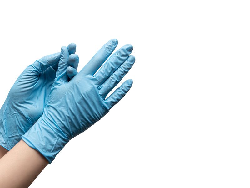 Female hands in disposable gloves on white background